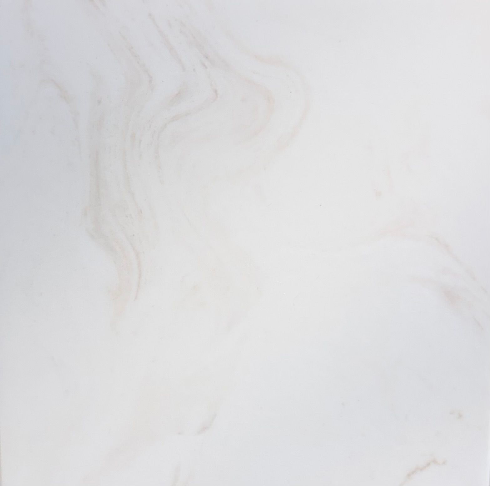 A close-up, top-down view of a textured dark gray stone surface with subtle white and green mineral veining throughout. A close-up, top-down view of a textured dark gray stone surface with subtle white and green mineral veining throughout.