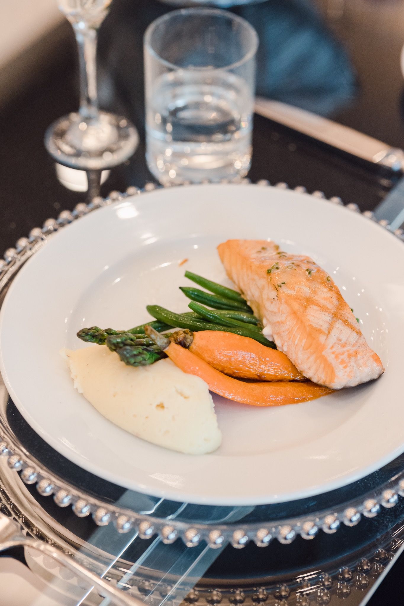 A plate of salmon and mashed potatoes with green beans, asparagus and carrots from the Banquet Menu. 