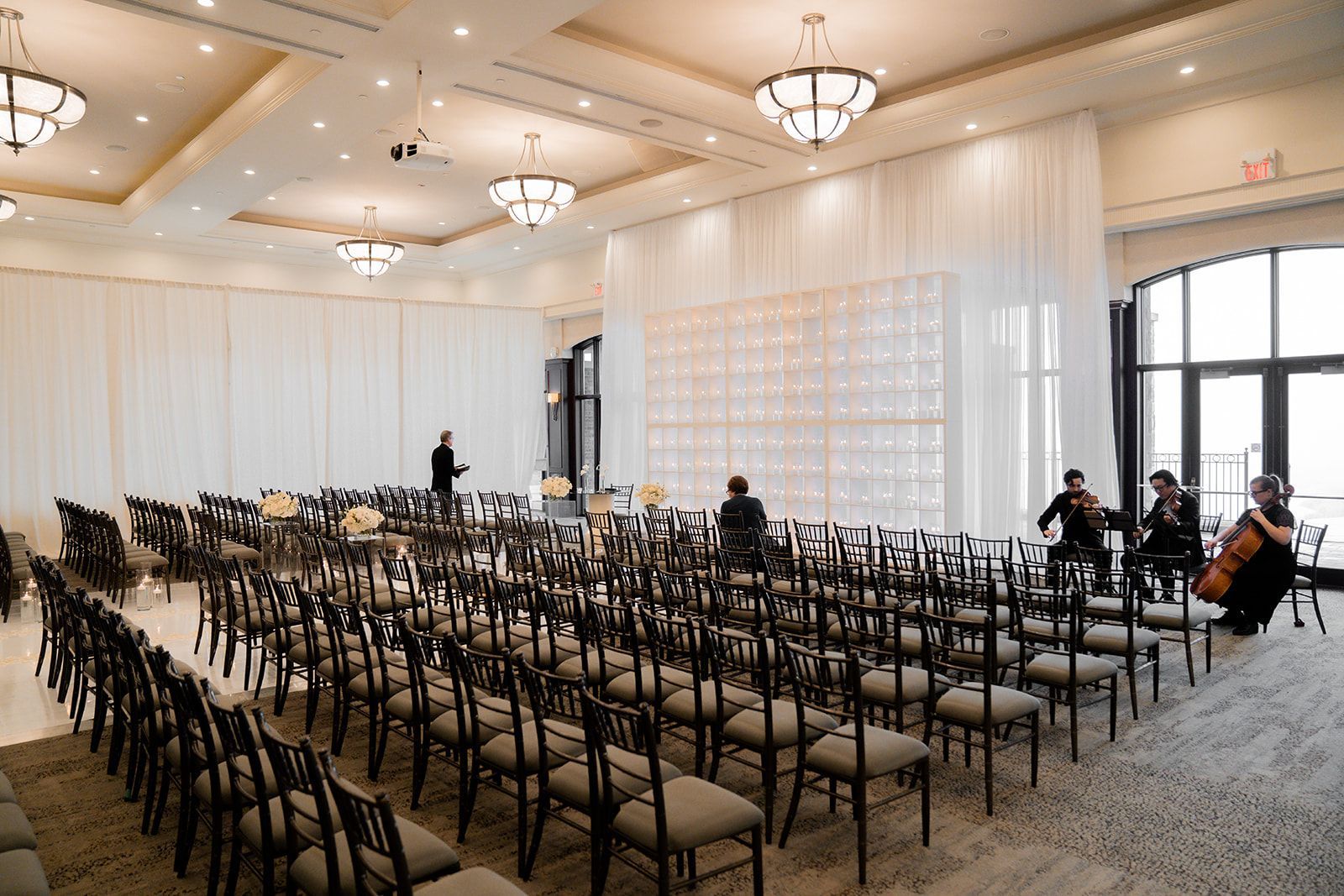 An angled view of an indoor wedding ceremony in the Great Hall. 
