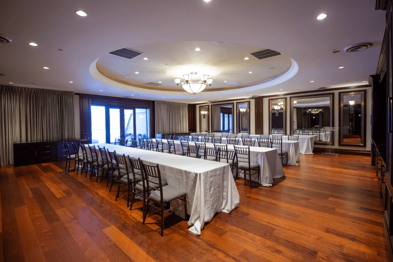 Three long tables set up in the Nest with large mirror across the back of the room.