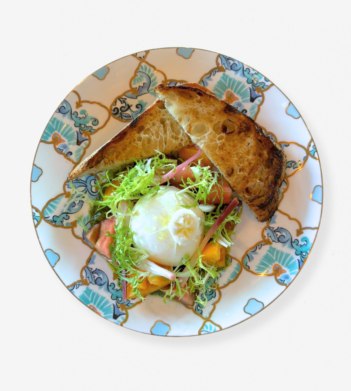 A white plate of Ontario Burratini on a white tablecloth-covered table. 