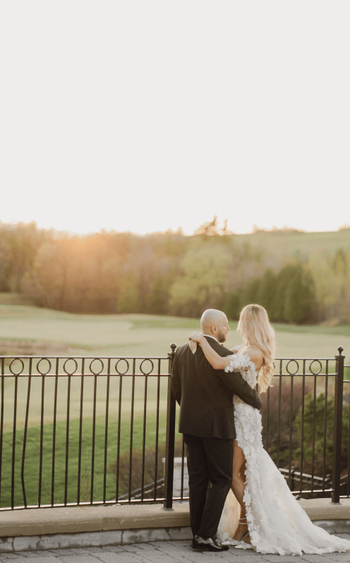 Married couple overlooking the Eagles Nest grounds, from the Great Hall terrace.