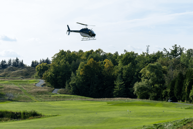 Helicopter flying over the golf course at Eagles Nest Golf Club.