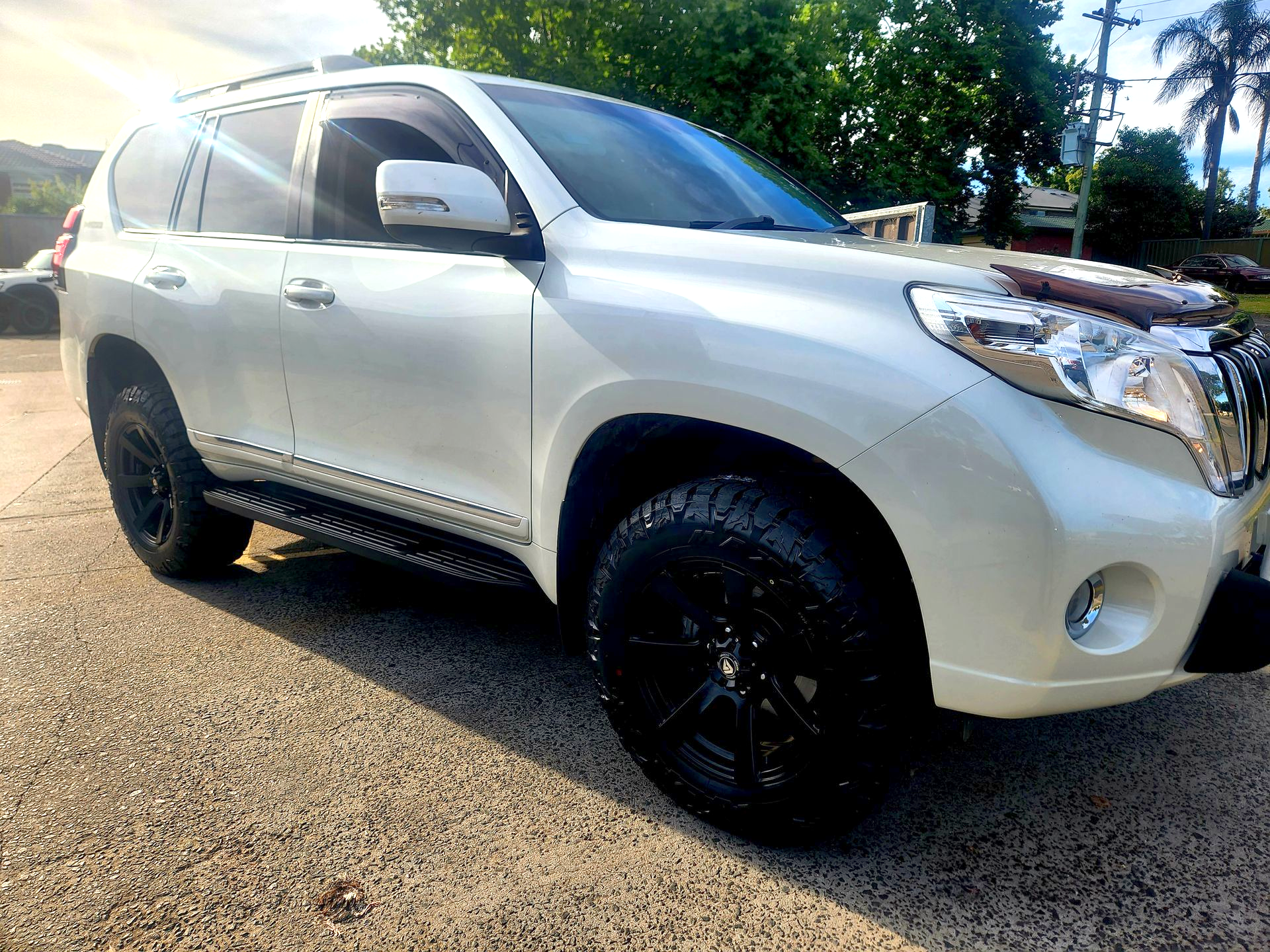 White Toyota Land Cruiser Prado SUV with Black Wheels Parked on Pavement — Autoplus Professionals Picton in Picton, NSW