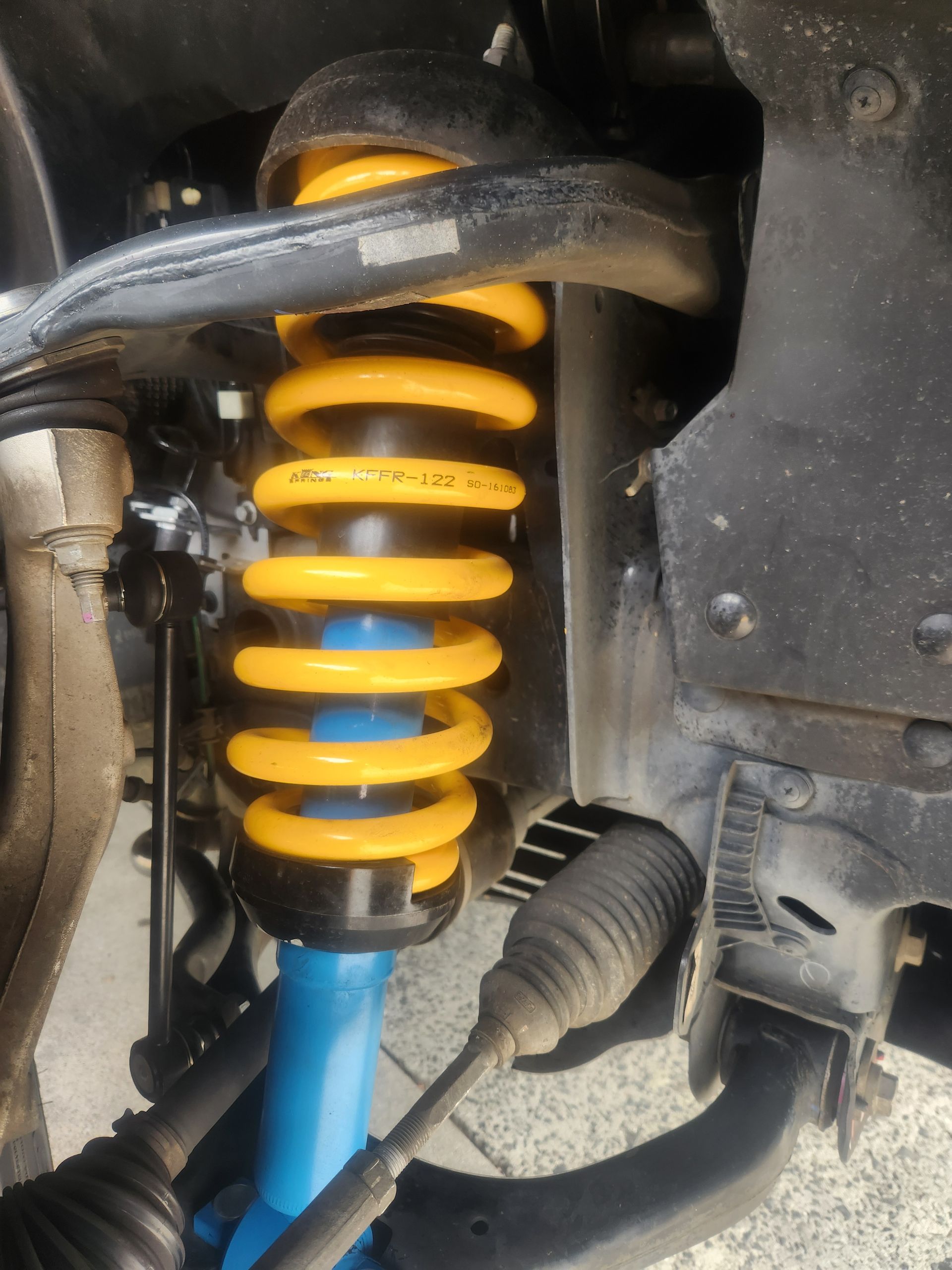 Yellow Coil Spring and Blue Shock Absorber on A Vehicle's Suspension System — Autoplus Professionals Picton in Picton, NSW