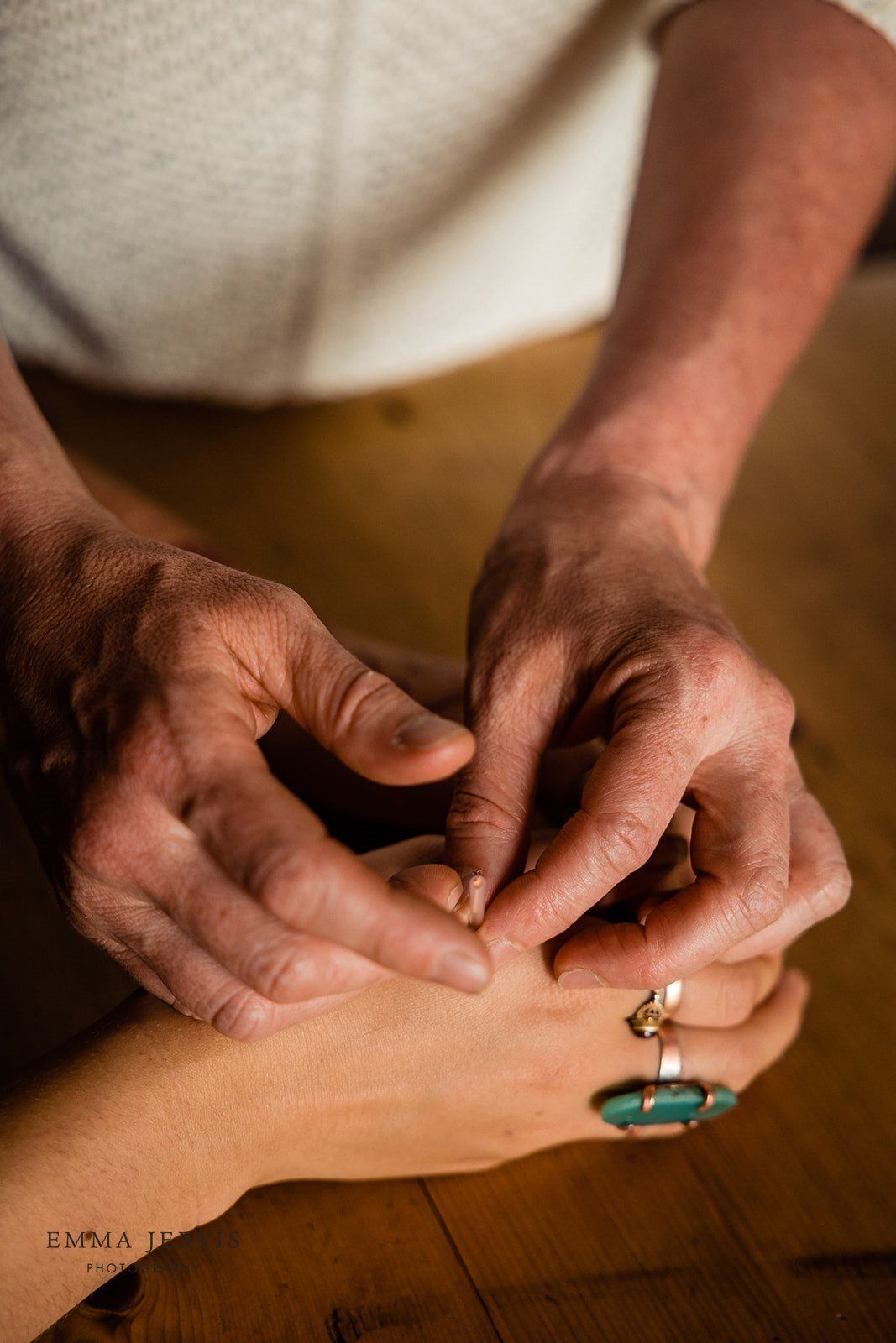a man is putting a ring on a woman 's finger .