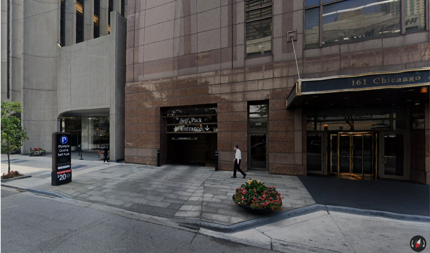 A man walking in front of a building that says the canadian