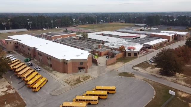 School with Buses on Parking Lot — Kernersville, NC — Bar Roofing & Maintenance