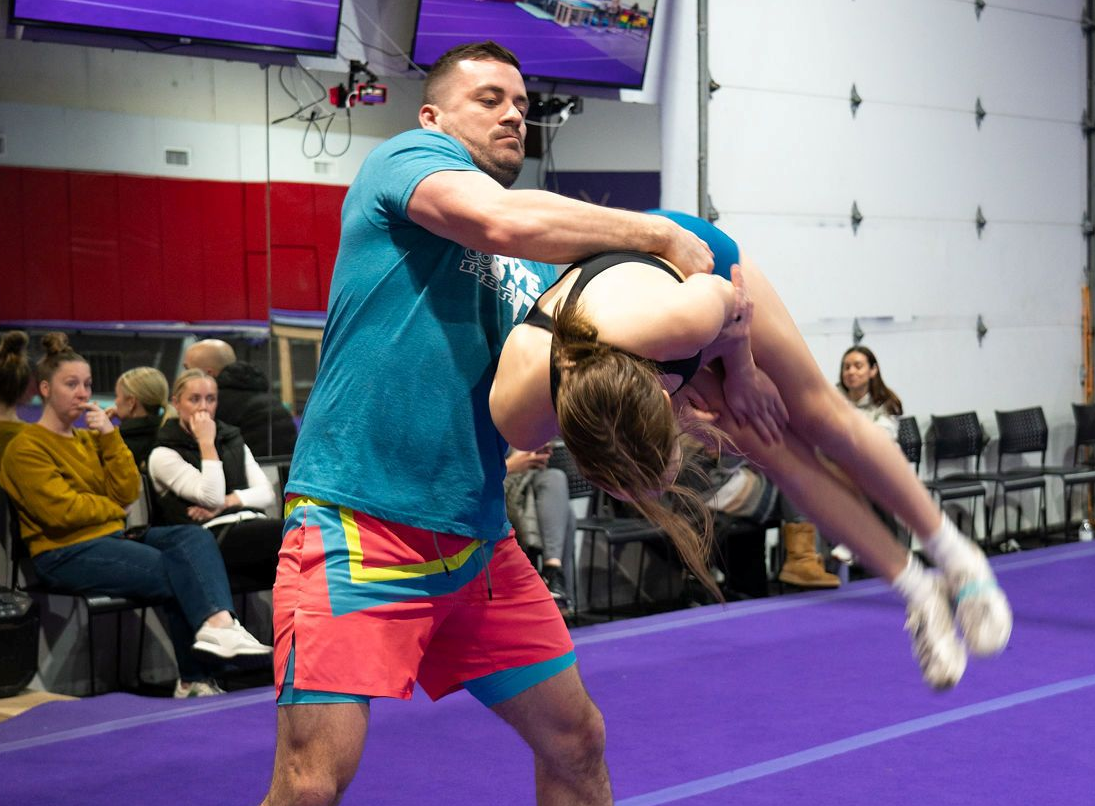 Tumble and Stunt Coach spotting a Layout