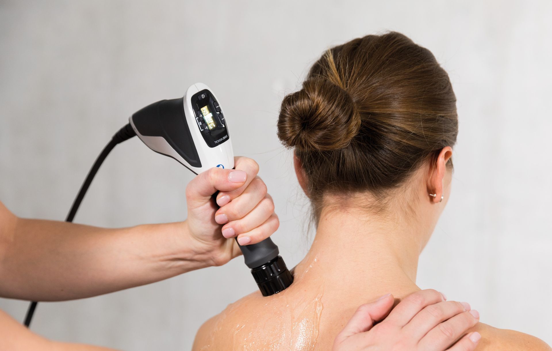 Bahrak at APEX Physiotherapy Derby treating neck pain with Shockwave Therapy