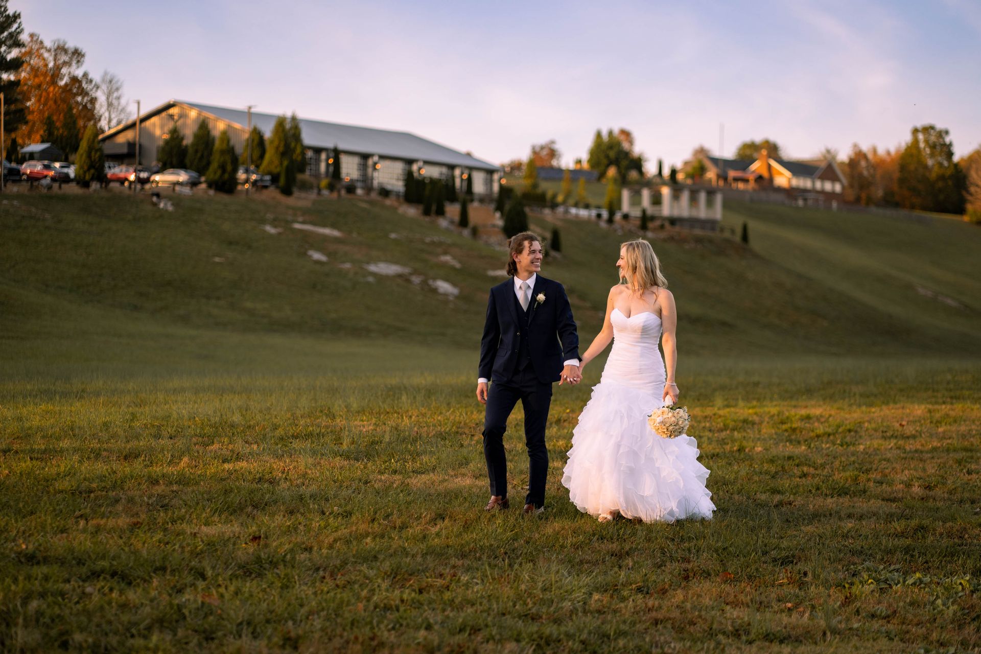 Bride and groom holding hands during sunset at Ocoee Crest. Photographed by a Chattanooga Wedding Photographer