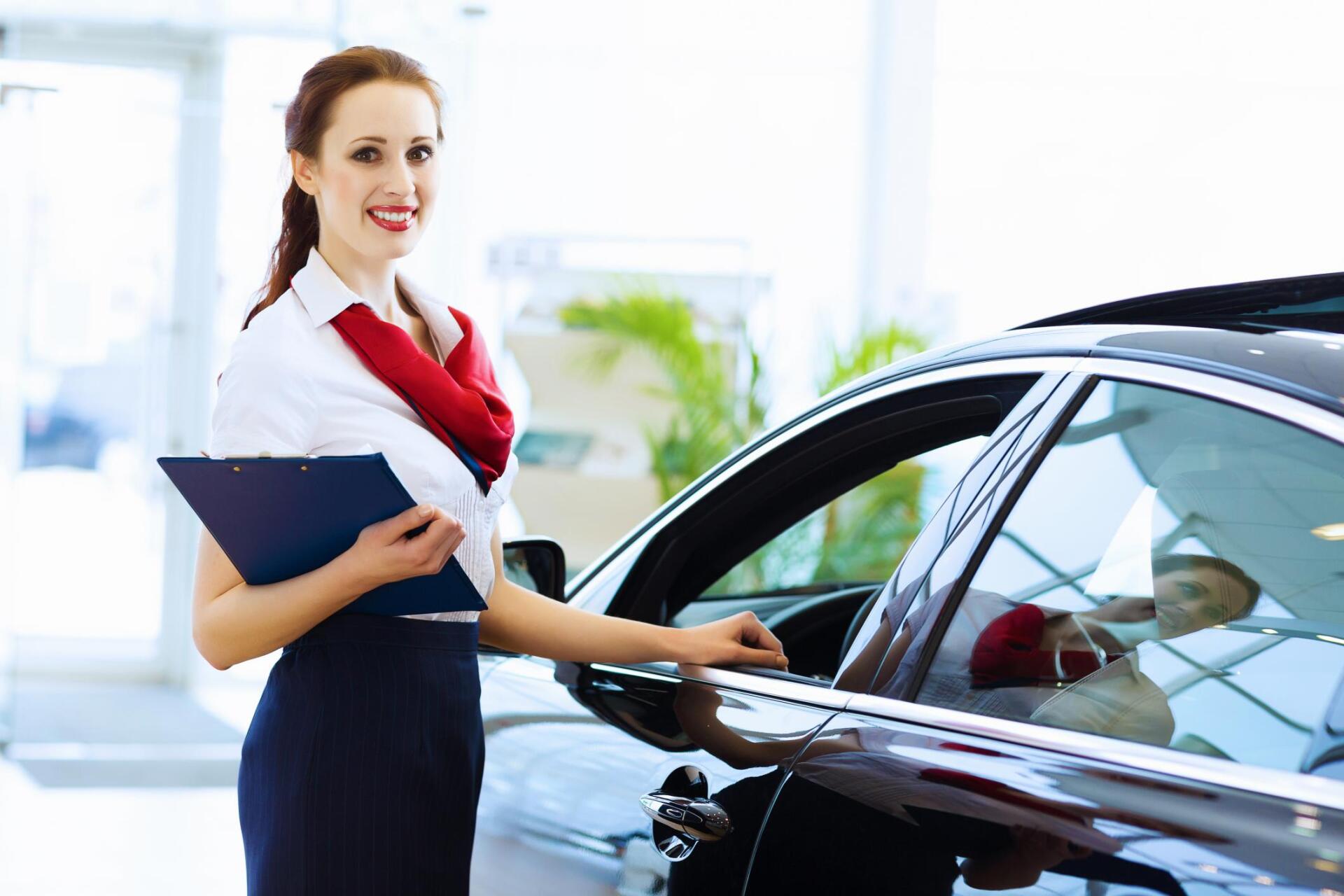 woman standing beside the car