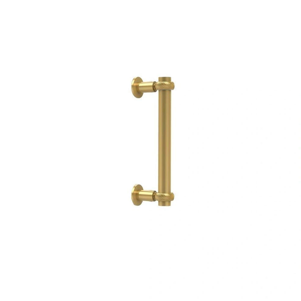 A brass handle on a white background that looks like the letter i.