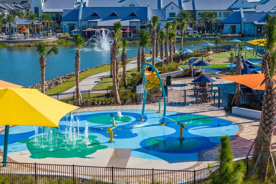 An aerial view of a water park with umbrellas and a fountain.