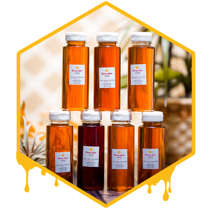 bottles of infused honey stacked on each other