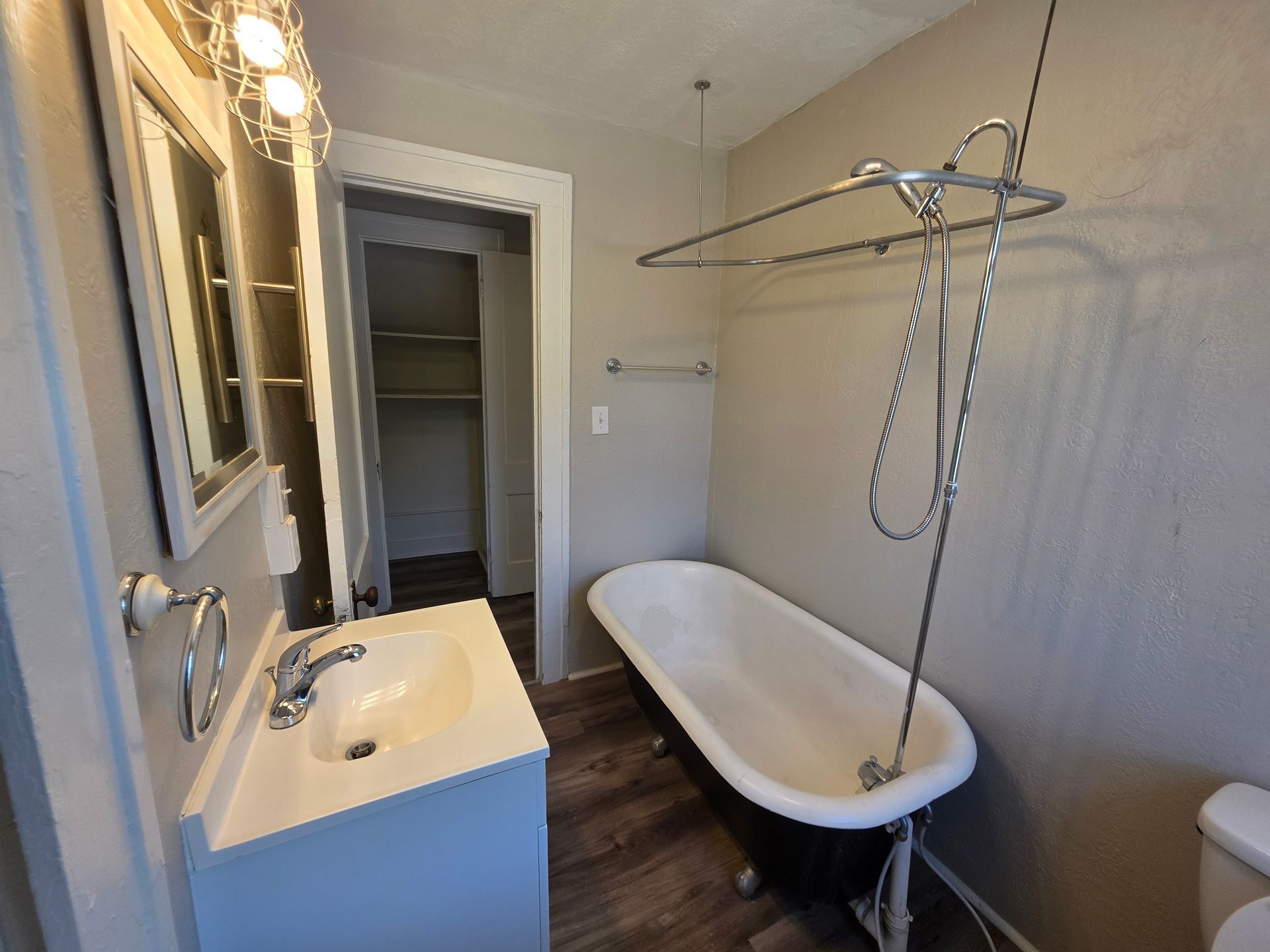 Vintage clawfoot soaking tub and updated shower system in historic Akron apartment.
