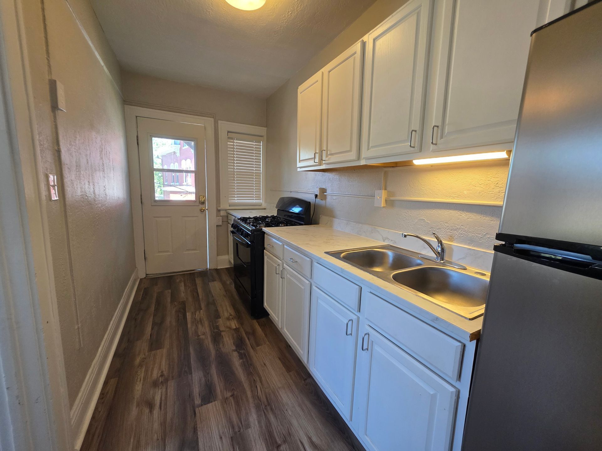 Updated kitchen with white cabinetry and modern appliances at 146 King Drive #3 Akron.