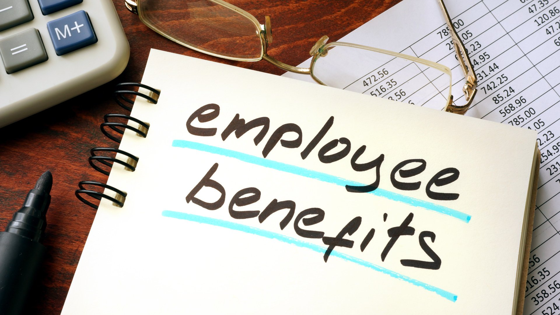 A notebook with the words employee benefits written on it
