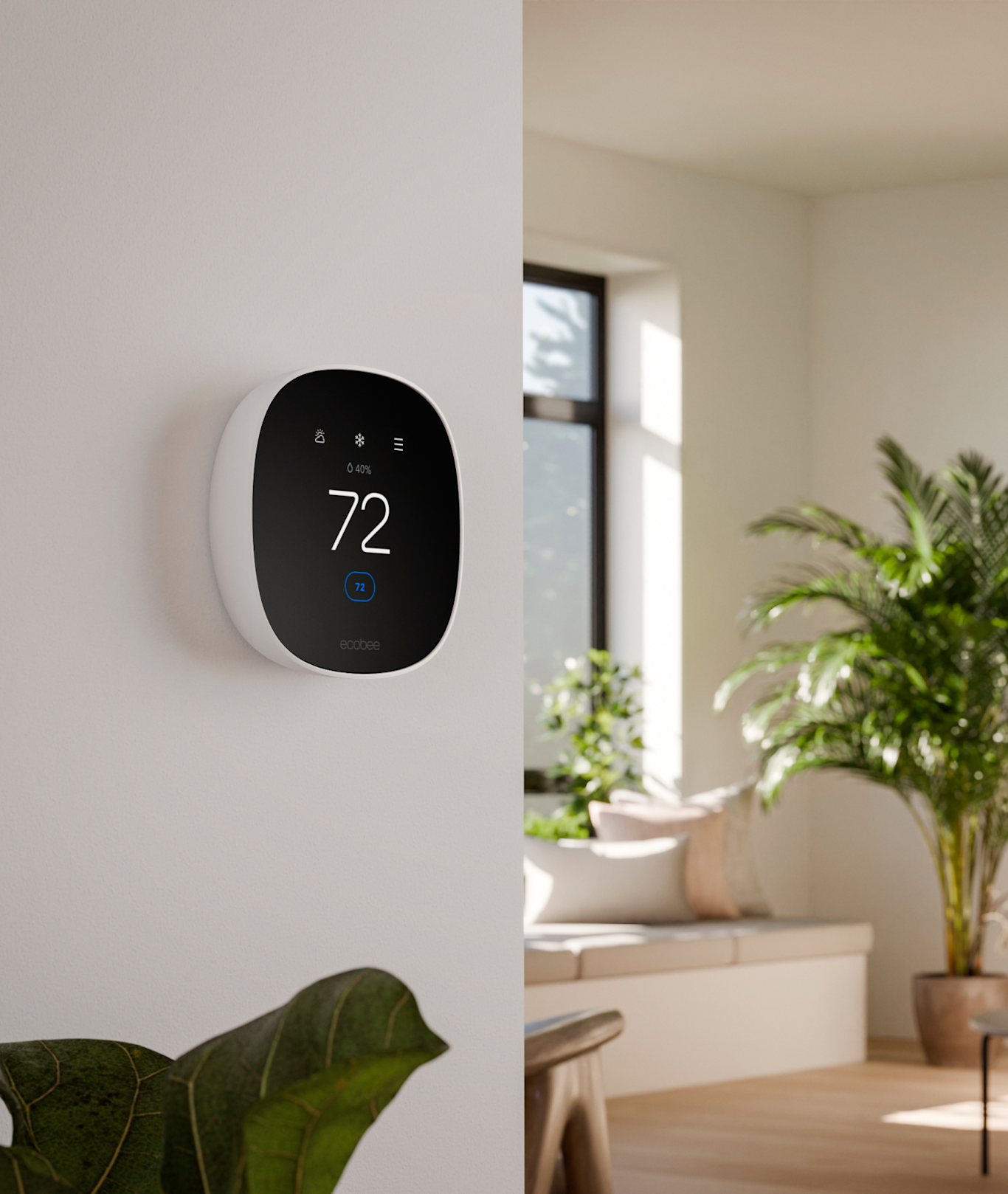 Black smart thermostat on a wall in a bright modern room, showing 72°