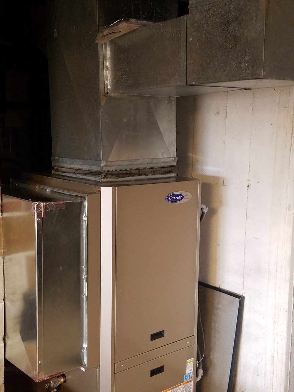 A carrier air conditioner is sitting in a dark room