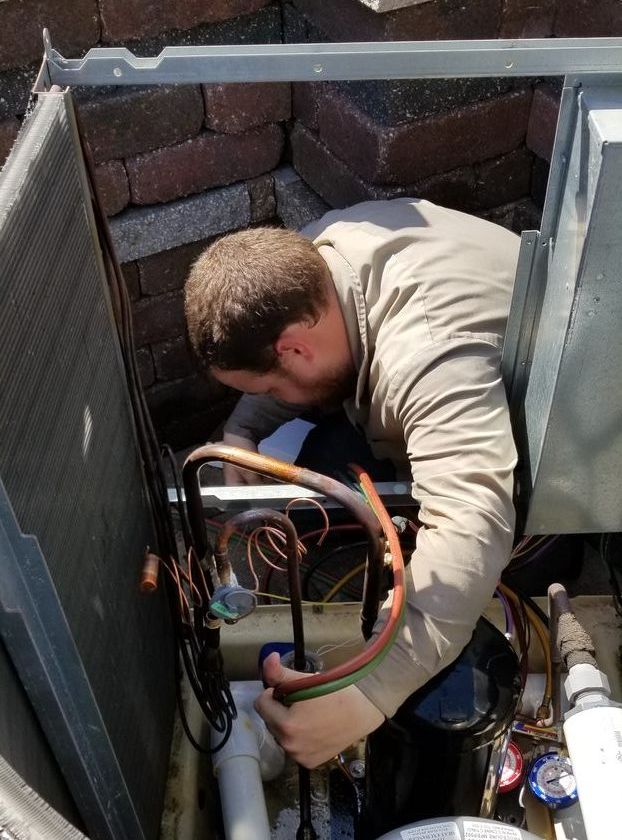 HVAC tech working in house