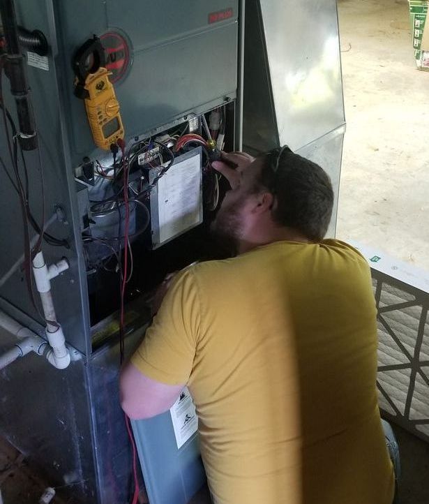 HVAC tech working in house