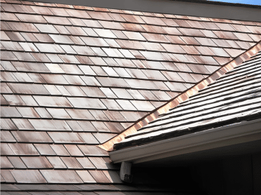 Five different roofing materials: wood, slate, dark tile, clay tile, and brown tiles.