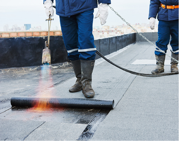 Joyland crew installing a modified bitumen membrane on a flat roof