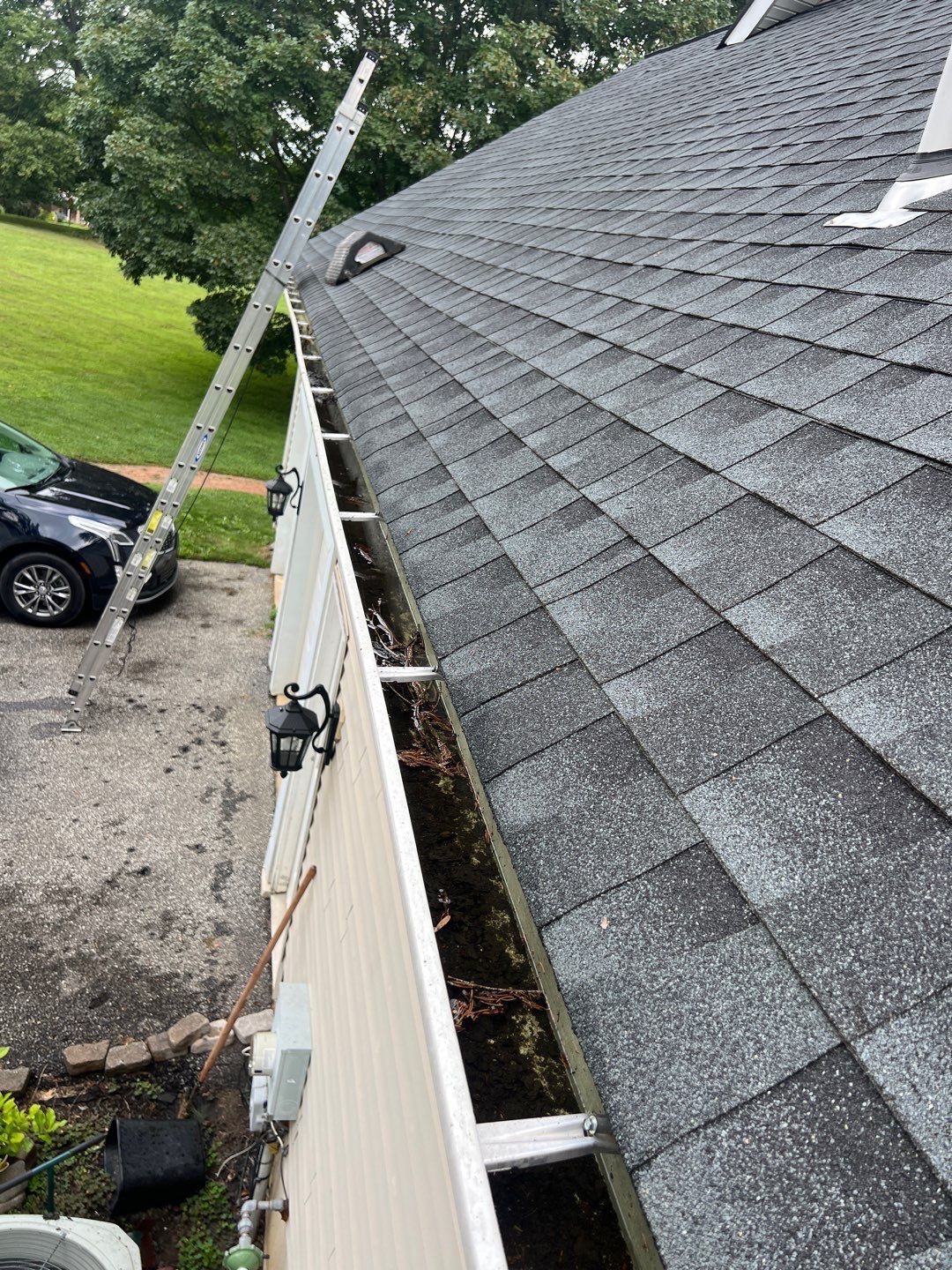 Asphalt shingle roof and debris-filled gutter on Wilson Avenue in Glen Mills PA