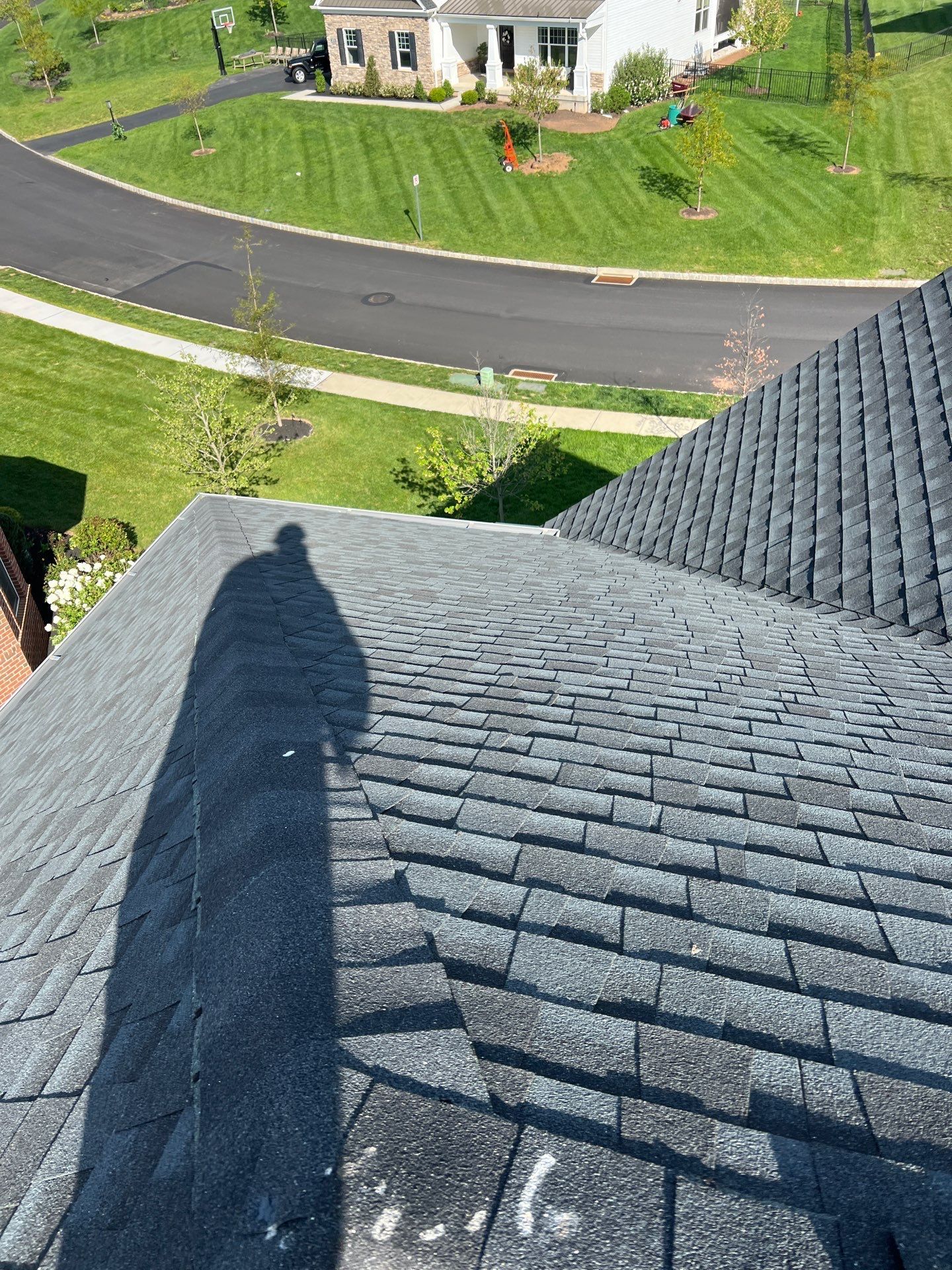 Roof repair and damaged shingles along a brick home on East Roberts Street in Norristown, PA
