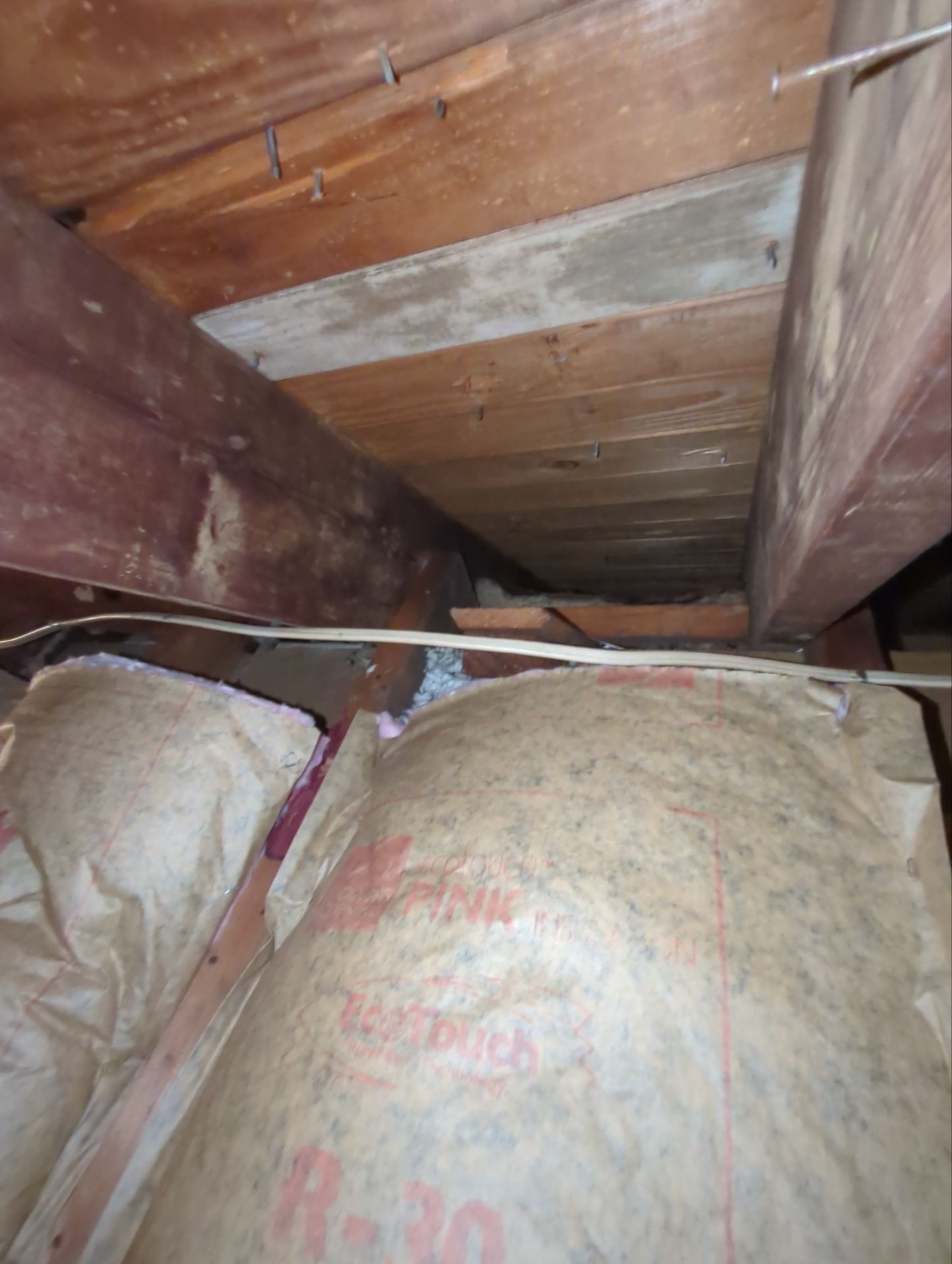 Attic roof framing and insulation visible during a roofing inspection on East Leamy Avenue in Springfield PA