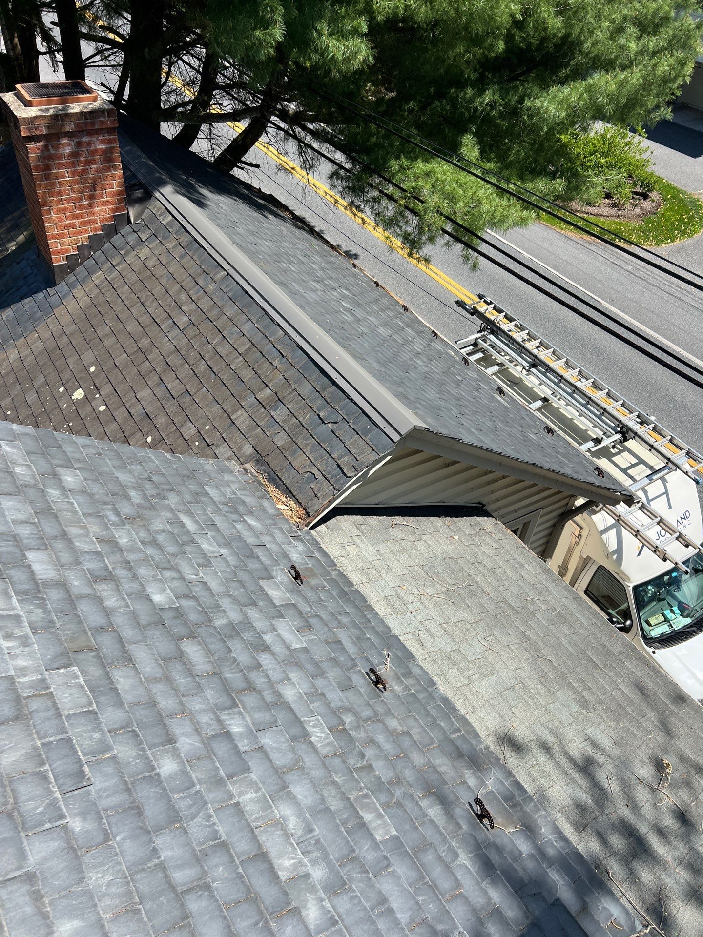 Roof repair in progress on an older slate roof on Blue Rock Road in Millersville, PA with flashing improvements and leak prevention work.