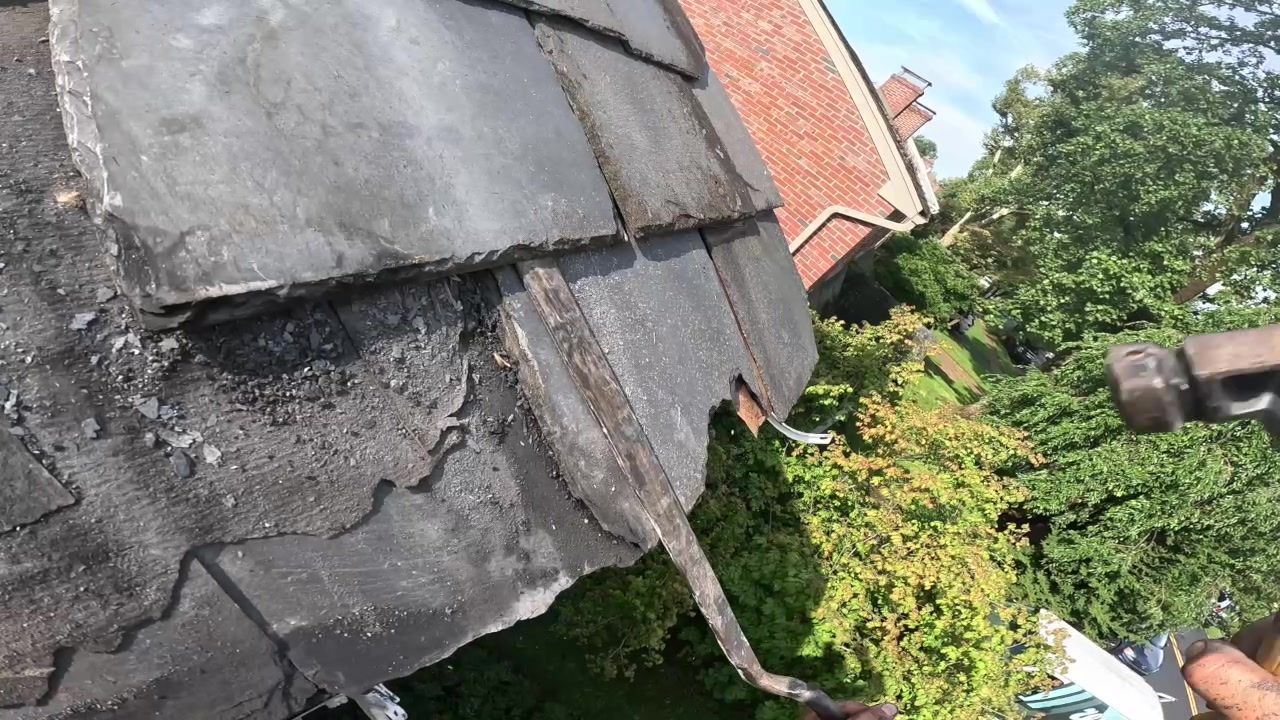 Exposed wood lath boards beneath slate during a roof repair in Lancaster PA