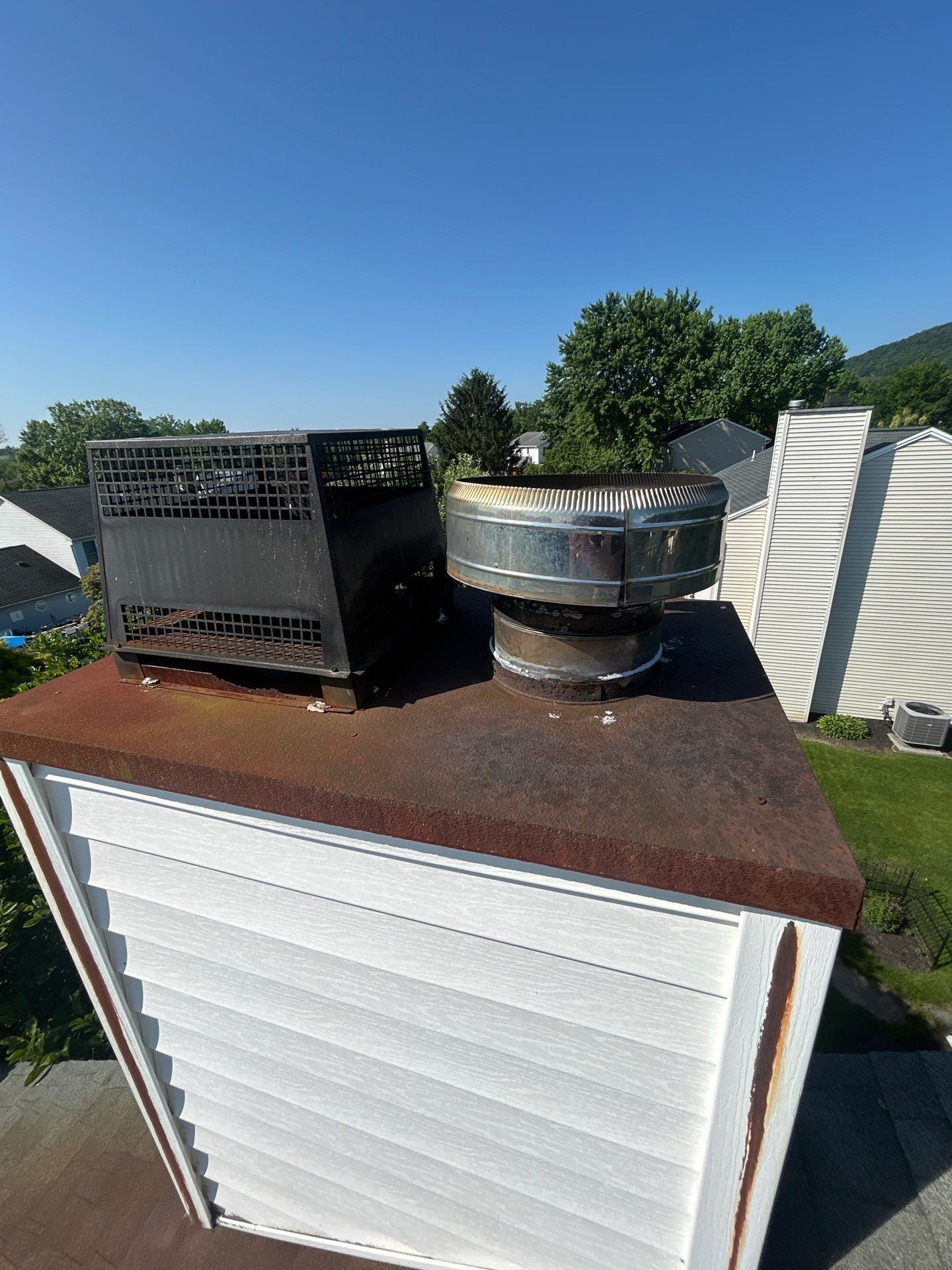 Metal chimney chase top and chimney cap replacement on Fairway Drive in Dillsburg, PA completed by Joyland Roofing.