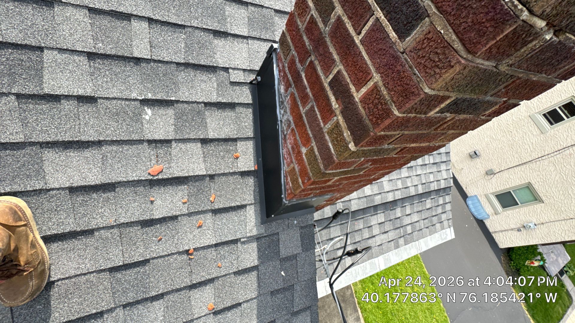 Chimney flashing repair completed on an asphalt shingle roof at a home on West King Street in Ephrata, PA.