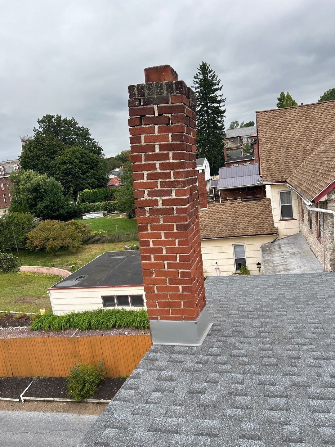 New asphalt shingle roof with professionally installed chimney flashing on a home along South Market Street in Schaefferstown, PA.