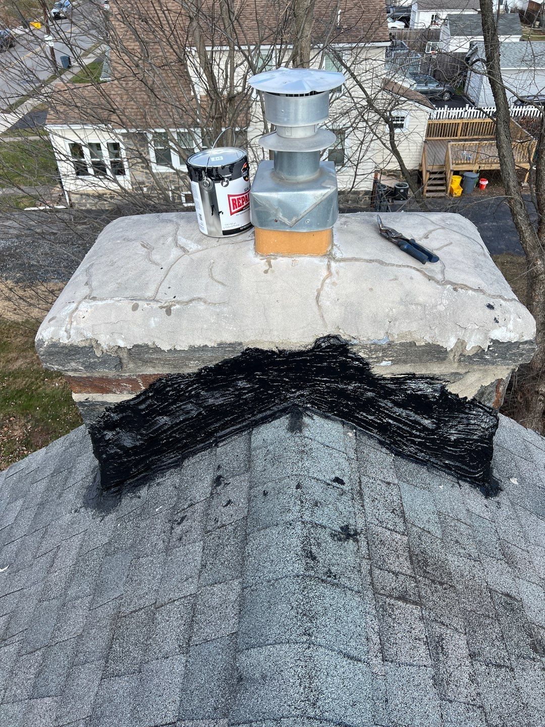 Chimney repair and roof flashing work on an asphalt shingle roof on Powell Road in Springfield PA