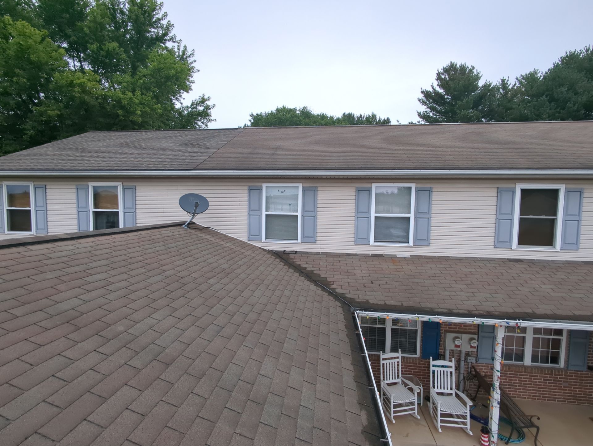 Brown asphalt shingle roof on a residential home with multiple roof sections and intersecting slopes in Quarryville, PA.