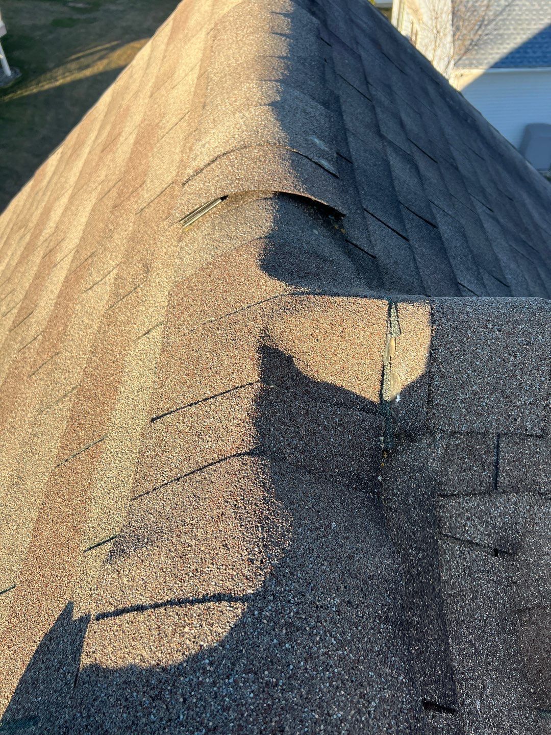 Damaged ridge cap shingles identified during a roof inspection by Joyland Roofing in Lancaster, PA.