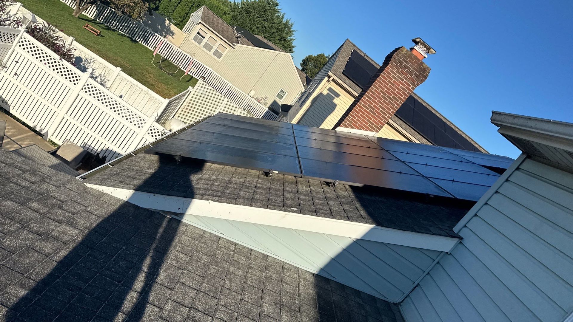 Asphalt shingle roof on Dogwood Lane in New Holland, PA with rooftop solar panels during a roof replacement inspection.