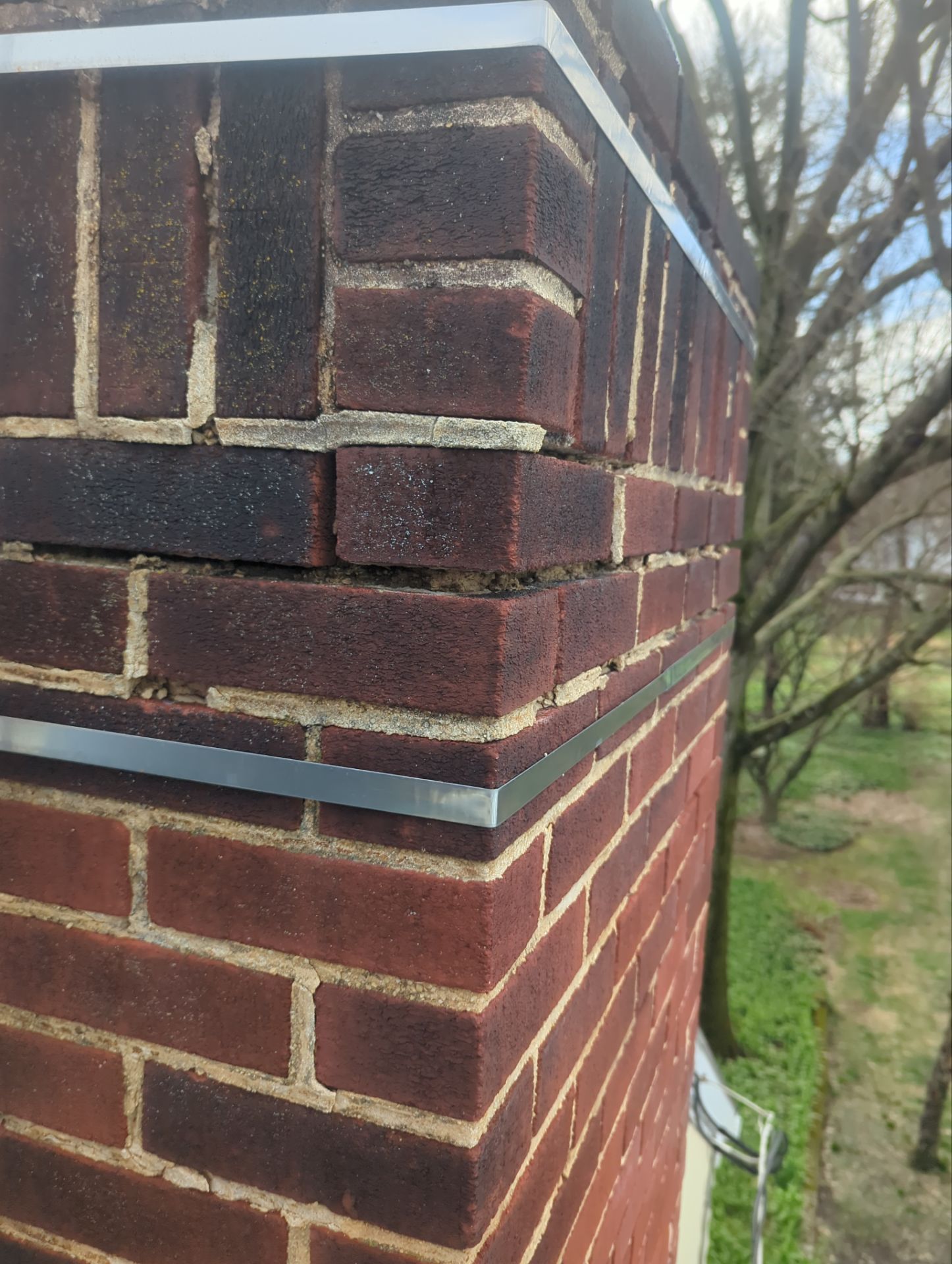 Brick chimney with fresh mortar joints after chimney repointing on East Main Street in Shiremanstown, PA.