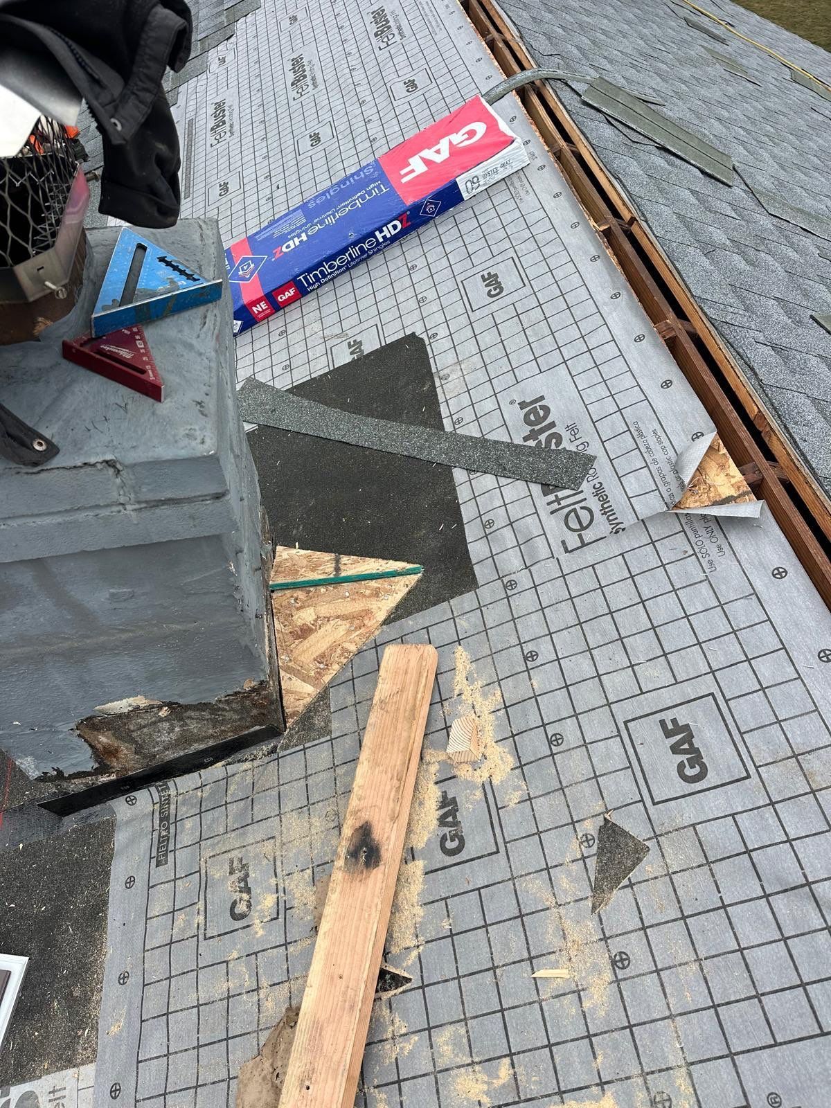 Roof replacement process on East Walnut Street in Annville, PA showing new GAF underlayment and chimney flashing installation by Joyland Roofing.