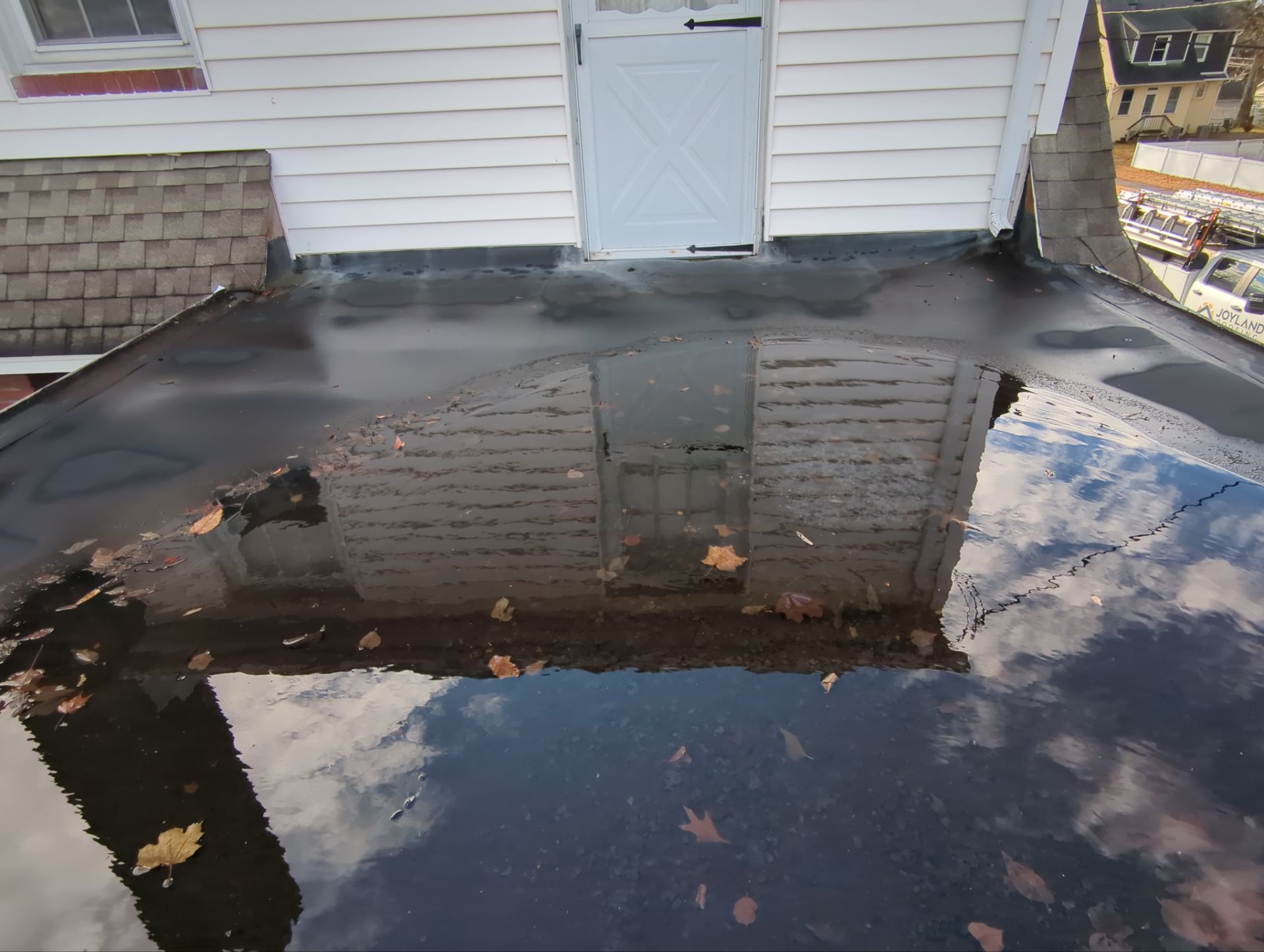 Flat roof replacement project completed on a home along Elm Street in New Cumberland, PA by Joyland Roofing.
