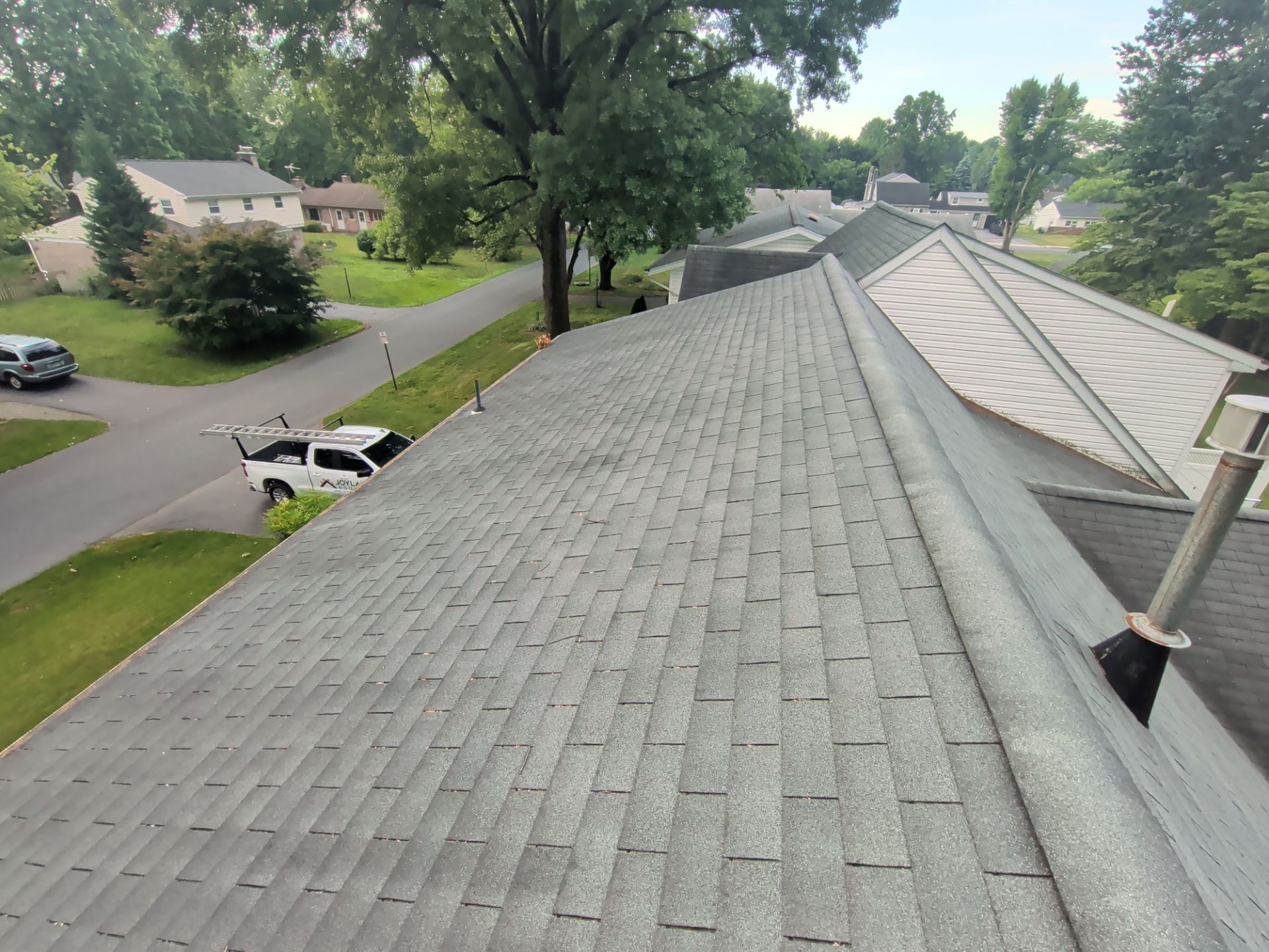 New asphalt shingle roof installed on a home on Farm Lane with clean ridge lines and professional workmanship.