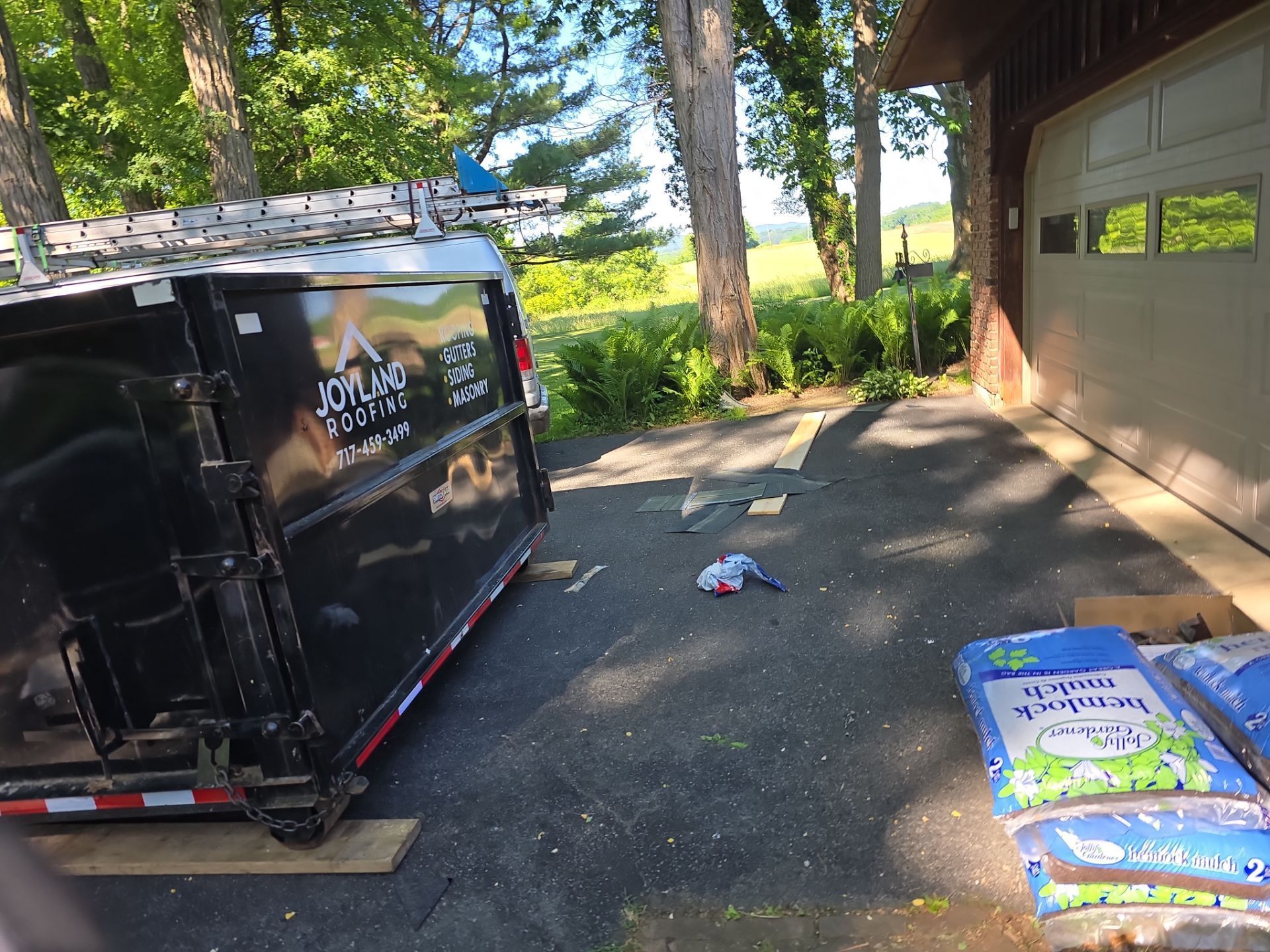 Joyland Roofing dumpster and equipment staged for a residential roof replacement project on Faust Road in Sinking Spring, PA.