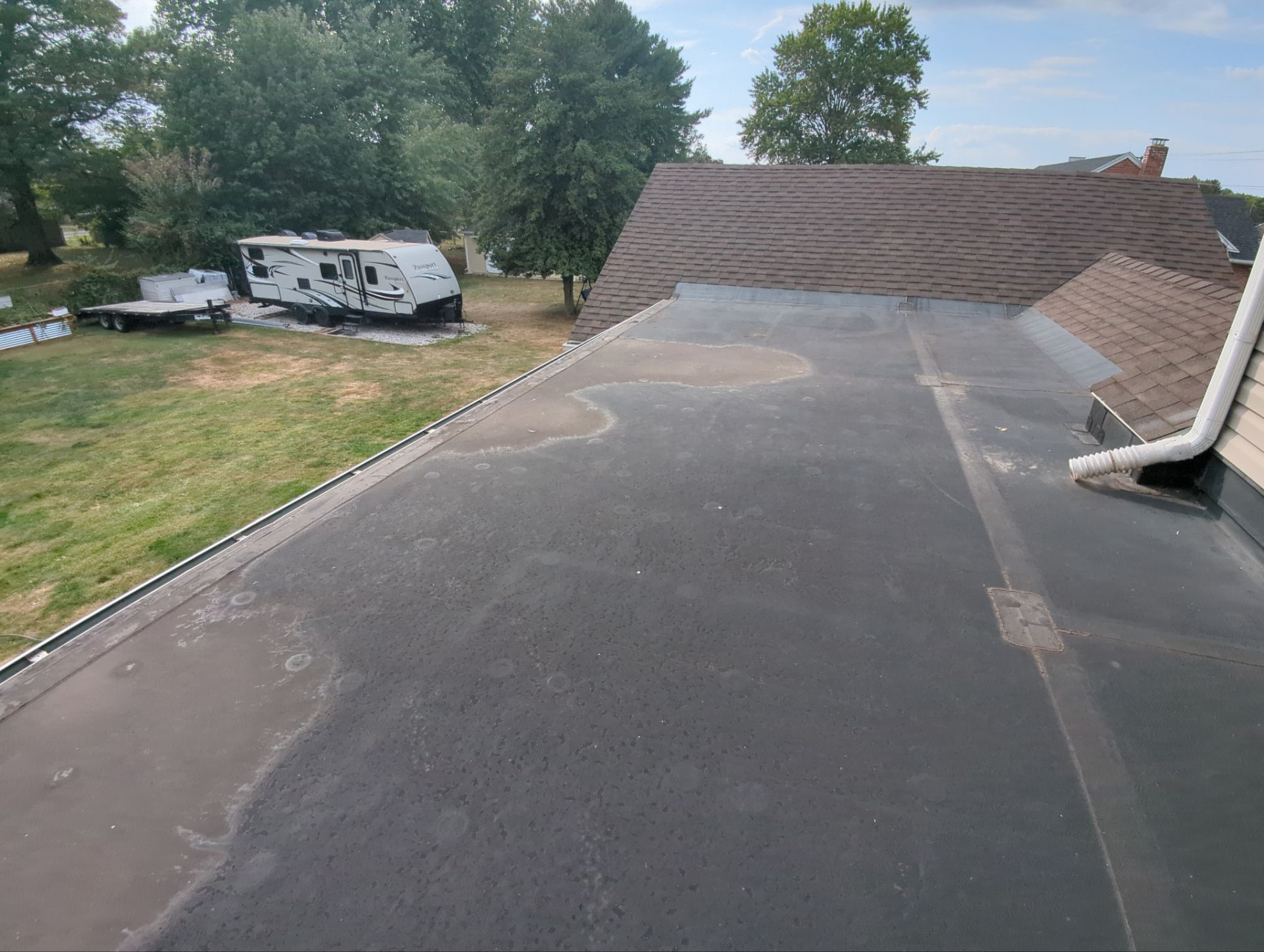 Low-slope flat roof inspection on Carlisle Road in Dover, PA showing the existing membrane roofing system before replacement.