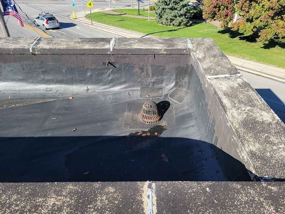 Flat roof drainage area on Maple Street in Manchester, PA inspected during a commercial roof replacement by Joyland Roofing.