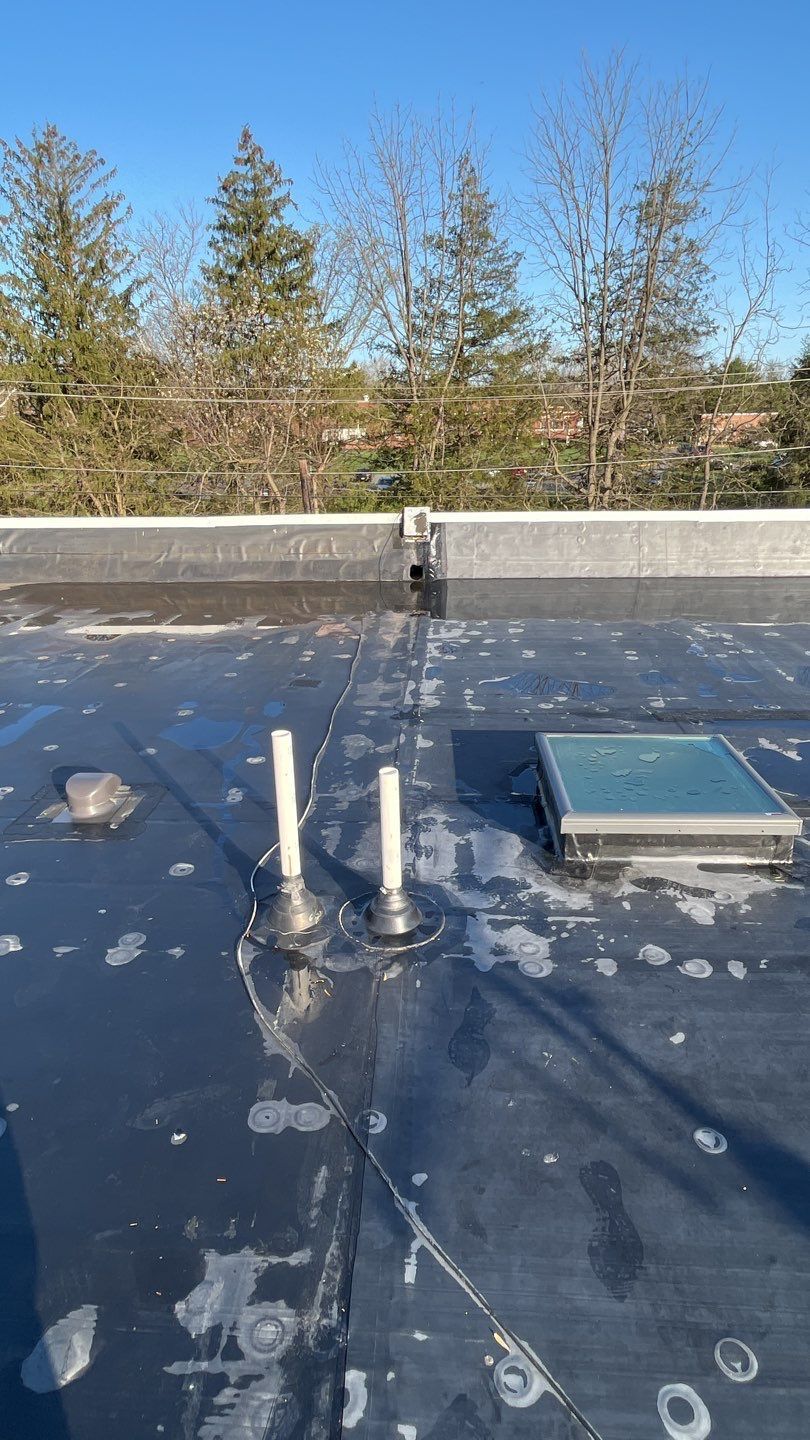 Flat roof inspection with skylight and vent pipes on Stanbridge Street in Norristown, PA
