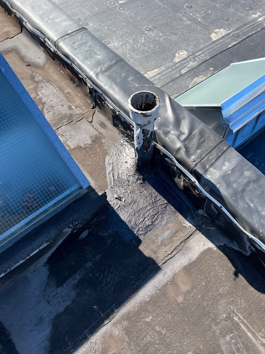 Flat roof repair around a drain pipe and skylight on Wells Street in Conshohocken, PA