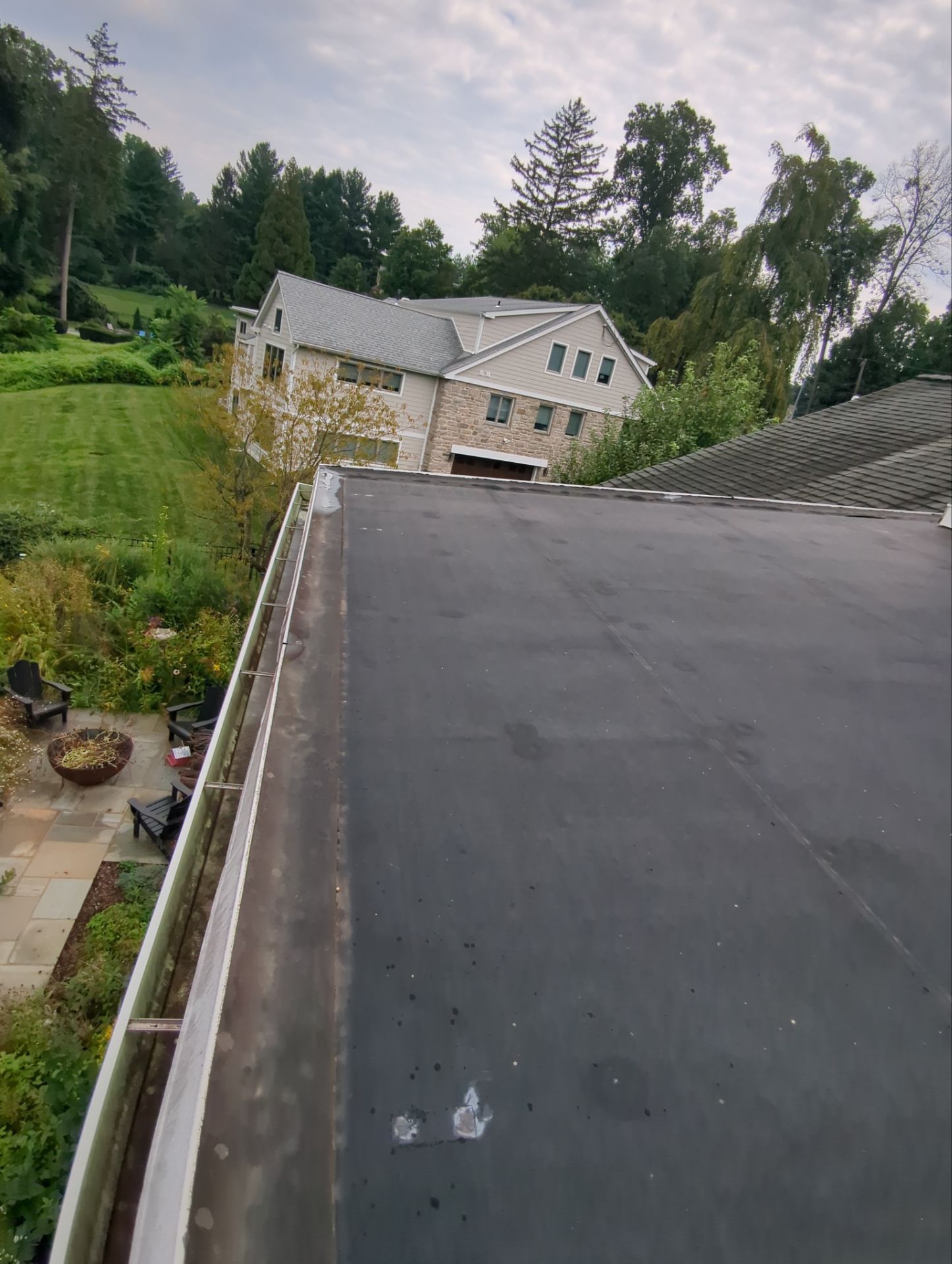 Flat roof replacement and drainage work by Joyland Roofing on Old Gulph Road in Wynnewood, PA